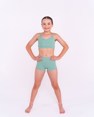 Front profile of girl wearing comfortable ribbed dance shorts and crop