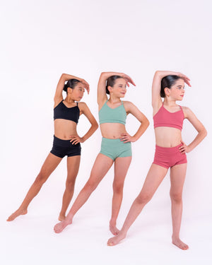 Stretching and warming up in comfortable ribbed dance shorts