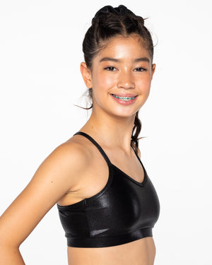 Person wearing a black sports bra against a white background