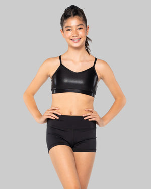 Woman wearing a black sports bra and shorts on a white background