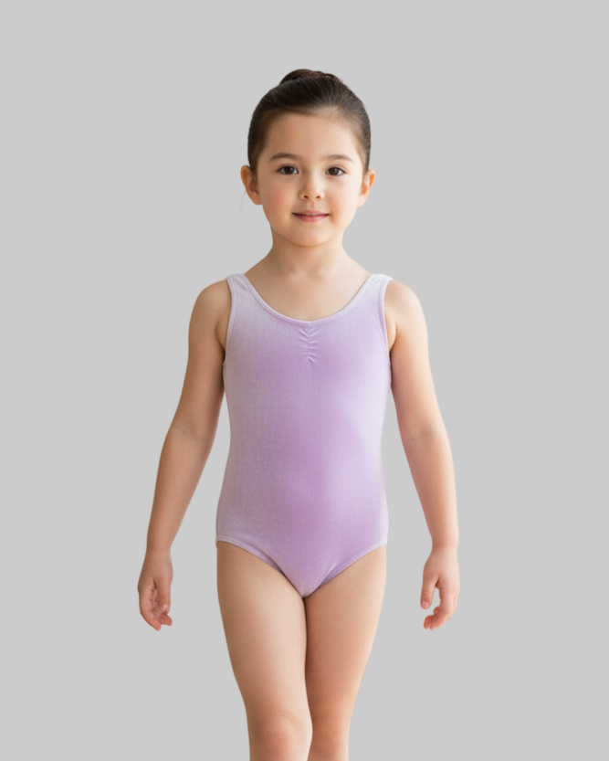 Young girl in a purple leotard standing against a plain background
